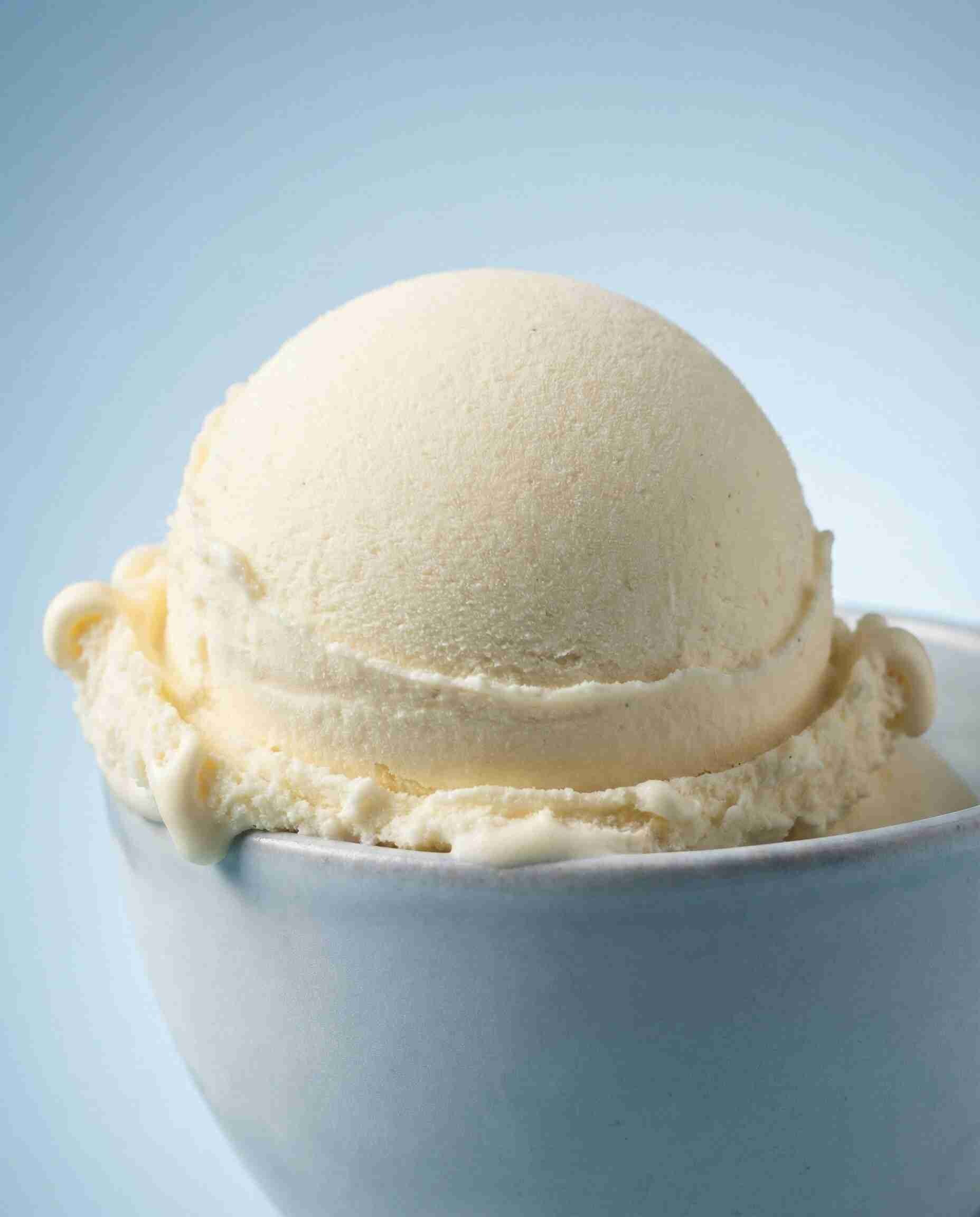 Solid waxy flakes of Polysorbate 61 surfactant, highlighting its solid physical state compared to liquid emulsifiers.