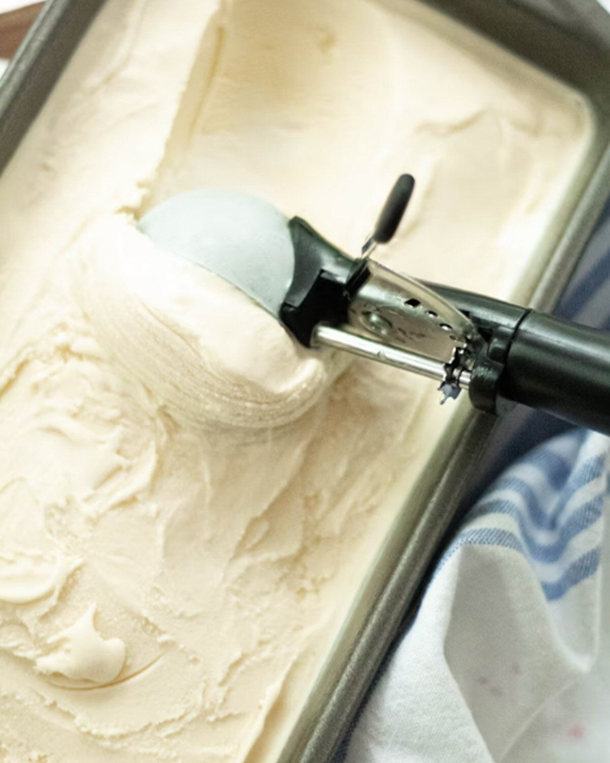 Scooping smooth homemade ice cream, highlighting improved aeration and creamy texture from Polysorbate 80.